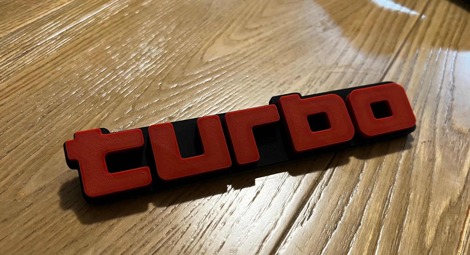 Turbo Grill badge angled red and black